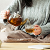 Woman pouring tea. Tea included in Elements Ritual Box.